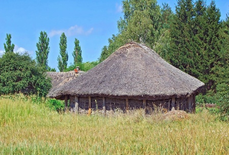 Ancient traditional ukrainian rural barn with a straw roofのeditorial素材