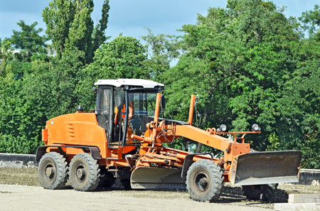 Orange bulldozer on bridge road construction site