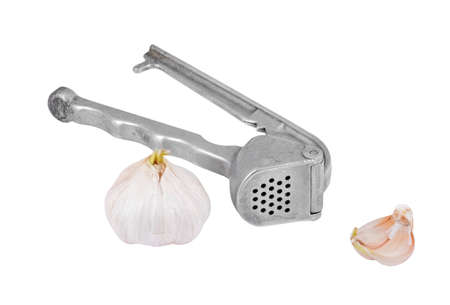 Garlic press and garlic, isolated on white background の写真素材