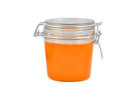 Glass jar with honey, isolated on white backgroundの写真素材