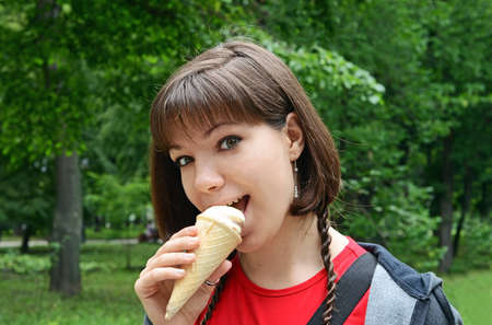 Young woman with ice cream in the parkの写真素材