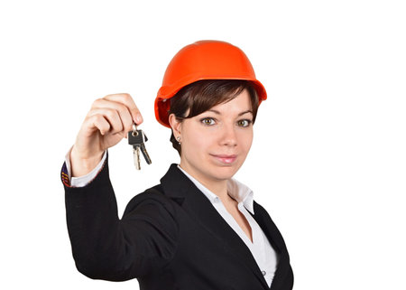 Smiling woman architect with key, isolated on white background