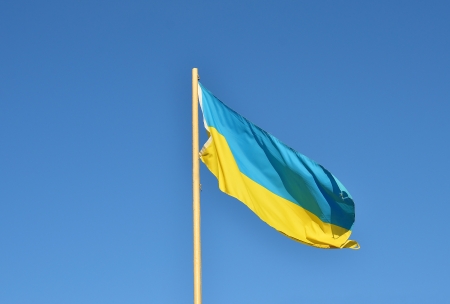 Flag of Ukraine waving against blue skyの写真素材