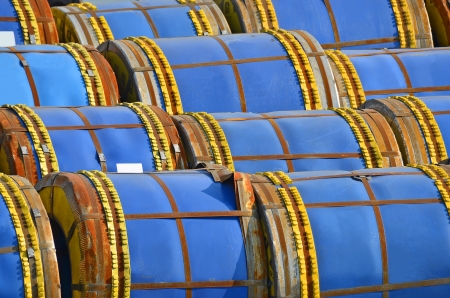 Stacked steel metal-roll ready for shipment in portの写真素材