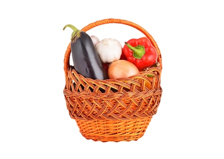 Vegetables in a wattled basket, isolated on white backgroundの写真素材