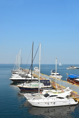 White motor yacht over harbor pier, Odessa, Ukraineの写真素材
