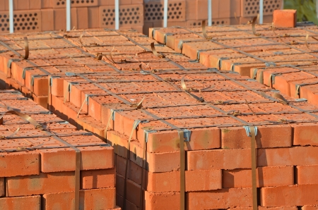 Stack of orange clay brick on palletの写真素材