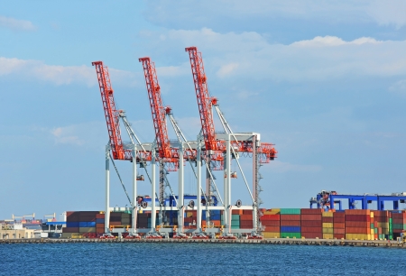 Port cargo crane and container over blue sky backgroundの写真素材