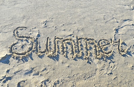 Word summer, written in sand of the beachの写真素材