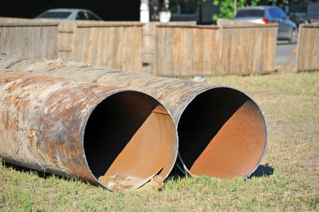 Large rusty steel pipe on construction site