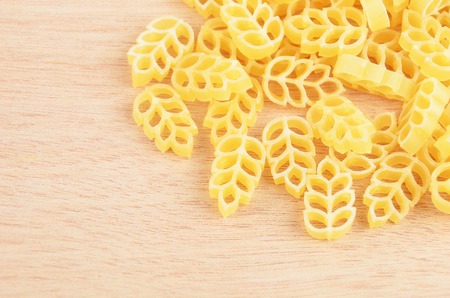 Close-up of wheat shaped pasta on wooden backgroundの写真素材