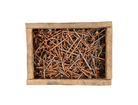 Rusty nail in wooden box, isolated on white backgroundの写真素材
