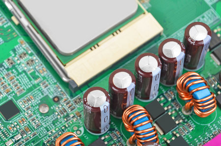 Green printed computer motherboard with microcircuit, close-up