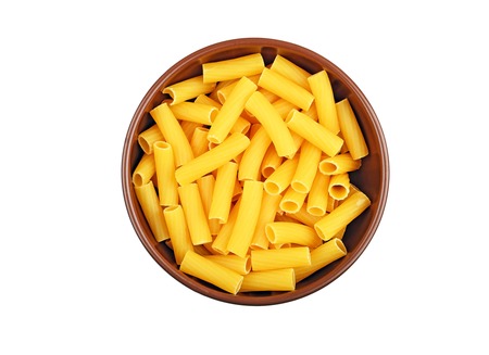 Wholegrain italian pasta in dish, isolated on white backgroundの写真素材