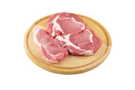 Raw meat steaks on wooden board, isolated on white backgroundの写真素材