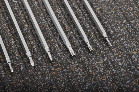 Screwdriver tools on spotted metal background, DOF