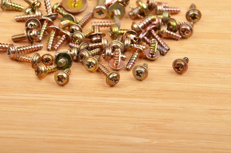 Some screw on a natural wooden backgroundの写真素材