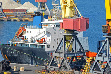 Bulk cargo ship under port crane bridge, Odessa, Ukraine