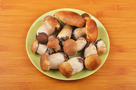 Boletus edulis mushroom on wooden board backgroundの写真素材