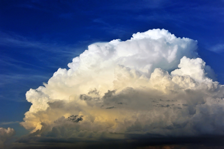Blue sky background with fluffy white cloudsの写真素材