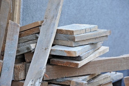 Old wooden beam, stacked at construction siteの写真素材