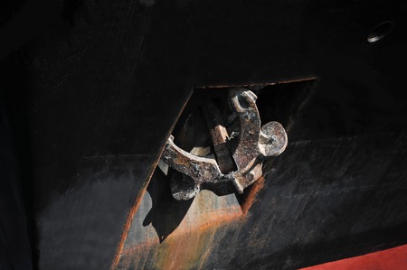 Rusty anchor mechanism on bulk ship hullの写真素材