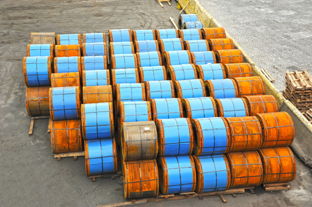 Stacked rusty rolled metal, ready for shipment in portの写真素材