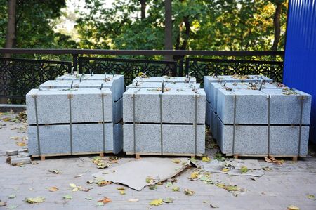 Stack of granite border stone on construction siteの写真素材