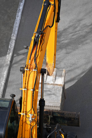 Work of excavating machine on building construction site
