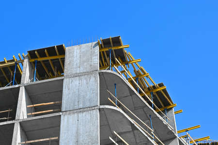 High-rise building construction site work with scaffoldingの写真素材