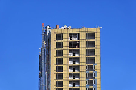 High-rise building construction site work with scaffolding