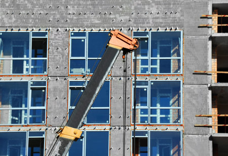 Crane and building from concrete and brick