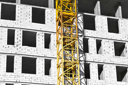 Crane and building from concrete and brickの写真素材