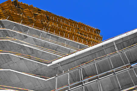 High-rise building construction site work with scaffoldingの写真素材