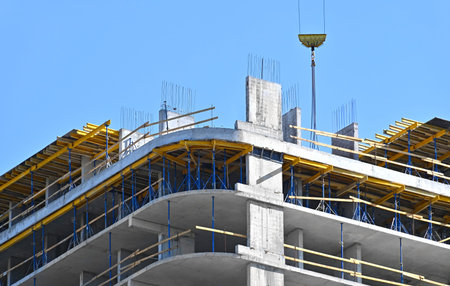 High-rise building construction site work with scaffolding