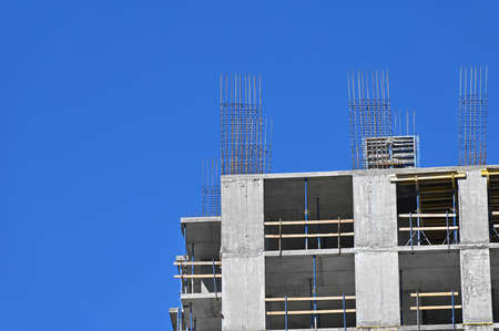 High-rise building construction site work with scaffoldingの写真素材