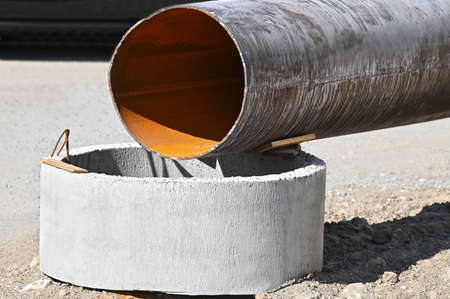 Concrete drain pit block and pipe on construction siteの写真素材