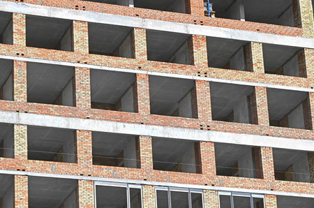 High-rise building construction site work with scaffolding