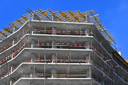 High-rise building construction site work with scaffolding