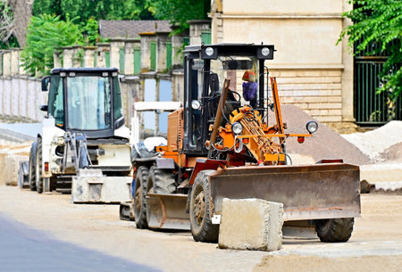 Grader machine on urban road construction site