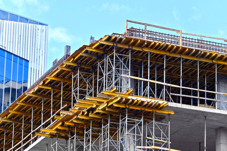 High-rise building construction site work with scaffolding