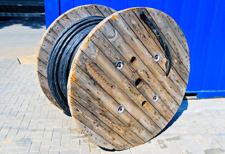 Wooden coil of electric cable on construction siteの写真素材