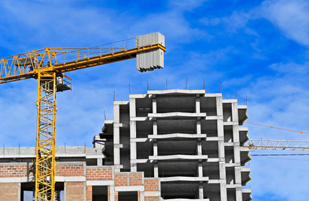 Monolithic construction site with crane and sky