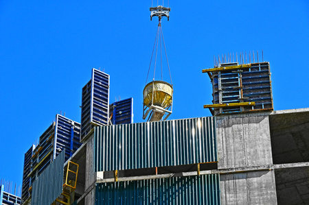 Crane lifting cone tank for concrete on construction siteの写真素材