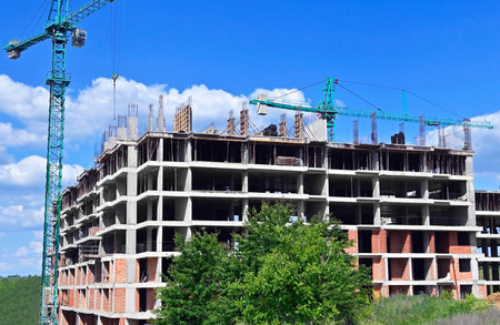 Monolithic construction site with crane and sky