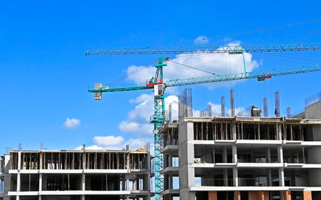 Construction site with tower crane and blue sky