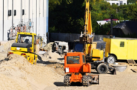 Bulldozer, excavator and compactor on urban construction site