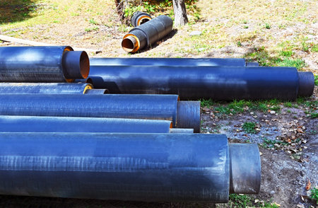 Steel pipe with heat insulation on construction siteの写真素材