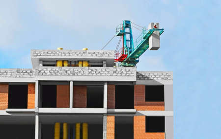 Highrise construction site and crane with blue sky