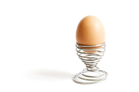Egg in a spiral eggcup, isolated on white background